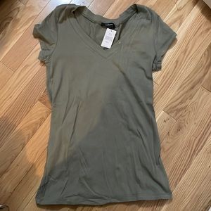 3 tshirts. White, green, and navy blue